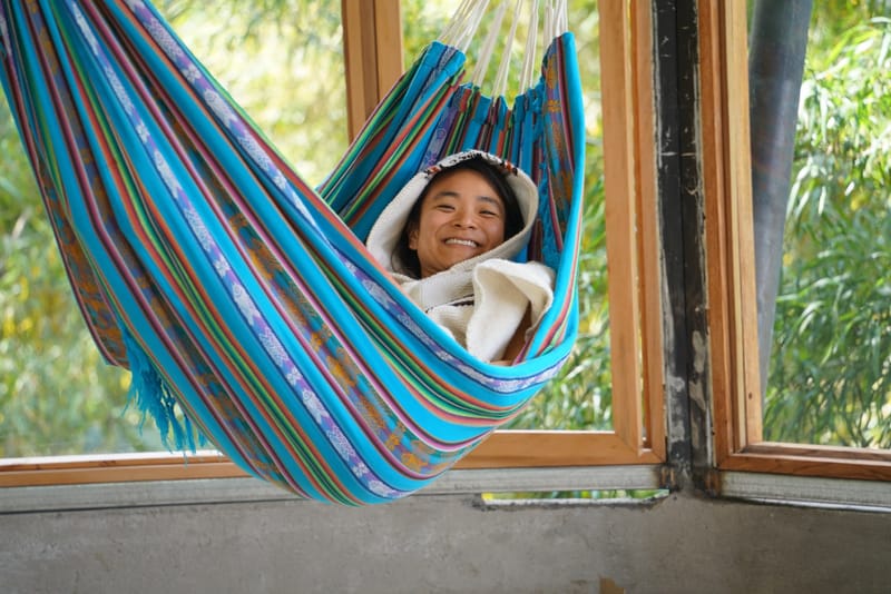 Guest relaxing in a colorful hammock at Amaroo